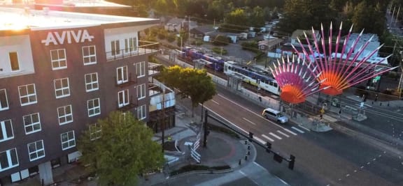 an aerial view of a city street with a ferris wheel and a bus on
