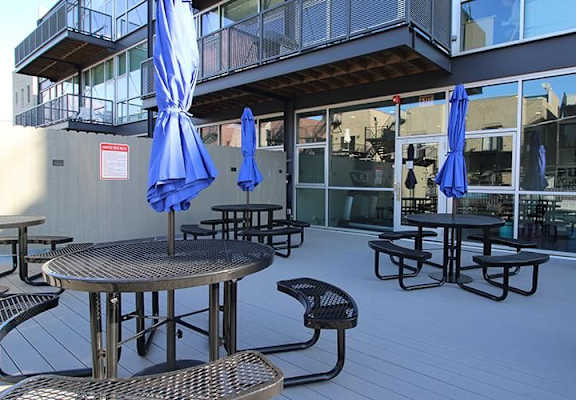 Community outdoor space at Highpoint Lincoln Park on Fullerton apartments in Lincoln Park, Chicago with seating and grills