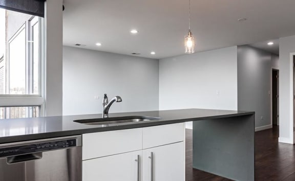 a kitchen with a sink and a large window