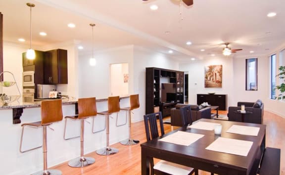 a living room and dining room with a table and chairs