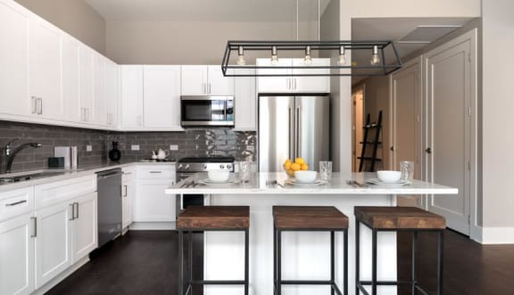 a kitchen with white cabinets and a white counter top