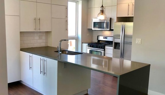 a kitchen with stainless steel appliances and a counter top