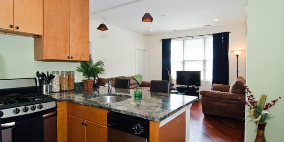 a kitchen with a counter top and a living room