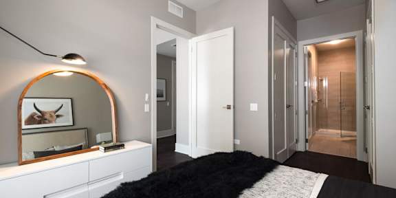 a bedroom with a mirror and a closet