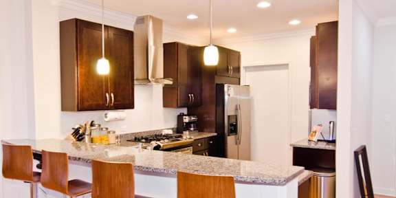 a kitchen with wooden cabinets and a granite counter top