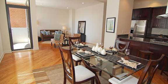 a living room and dining room with a glass table