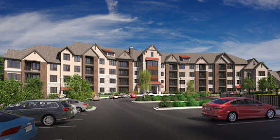 A row of apartment buildings with cars parked in front.