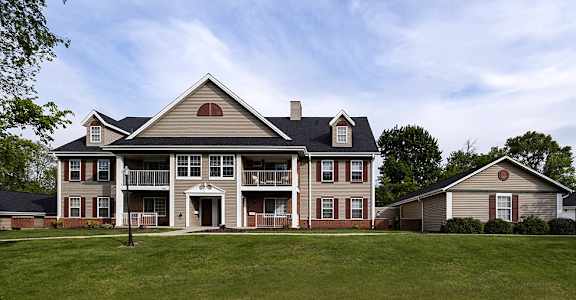 a large house with a yard in front of it