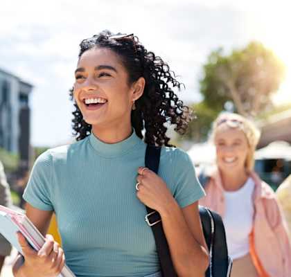A group of students walking on a sunny day.