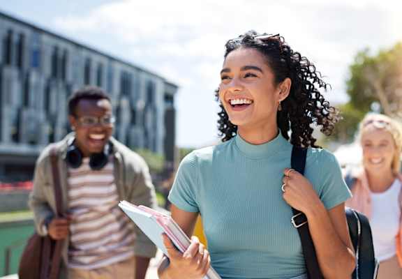 A group of students walking on a sunny day.