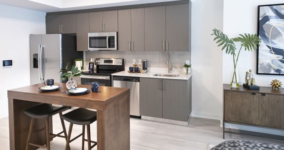a kitchen and dining area in a 555 waverly unit