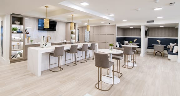 a resident clubhouse with stools and tables
