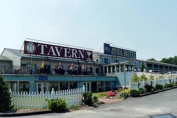 A Tavern sign is on a building.