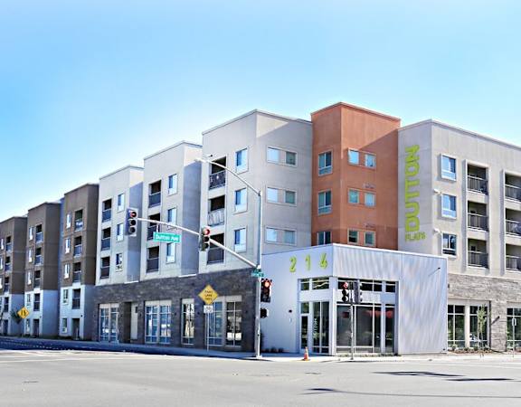 A street view of a multi-story building with the name "Parklands" on the side.