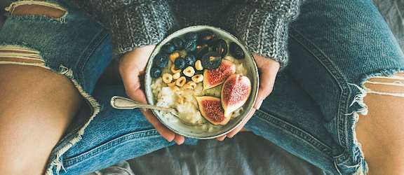 Woman holding a bowl of fruit at Salish Flats APARTMENTS, Airway Heights, WA 99001