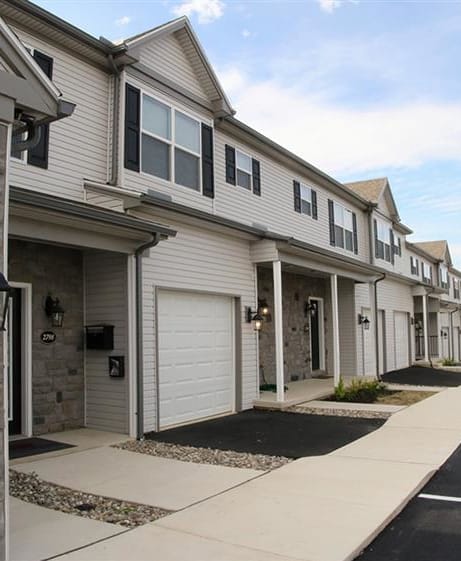 a row of three story houses on a street