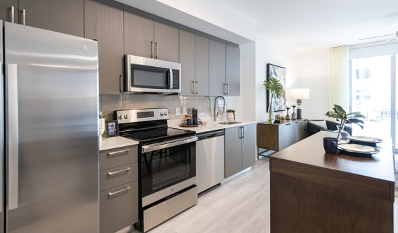 a kitchen with stainless steel appliances and a wooden counter top