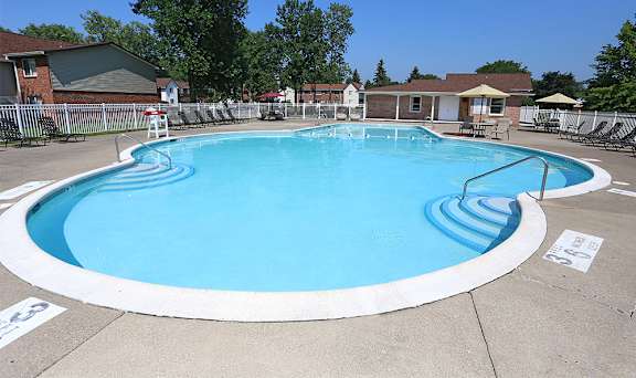 A round blue swimming pool with a white border.