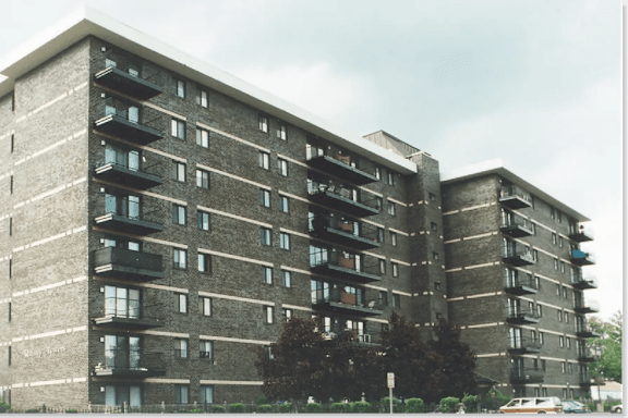A large concrete building with balconies on each floor.