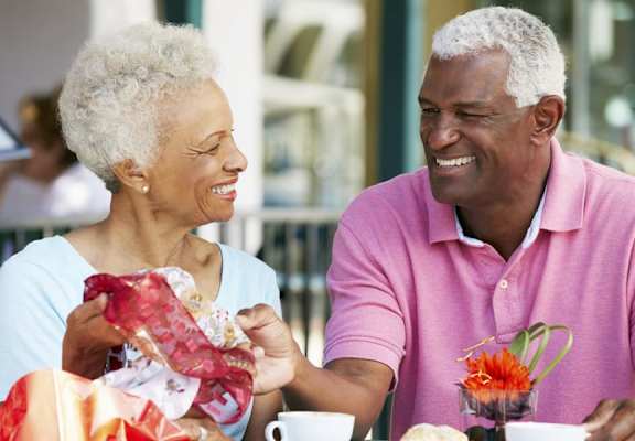 elderly couple smiling at each other