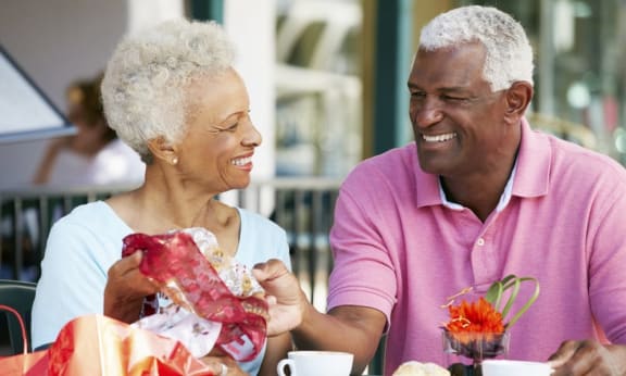 Elderly couple smiling at each other