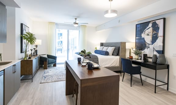 a bedroom with a bed and desk in a 555 waverly unit