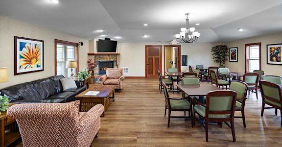 a large living room with a dining room table and chairs