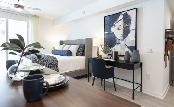 a bedroom with a bed and desk in a 555 waverly unit