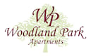 A logo for Woodland Park Apartments with a tree and leaf design.