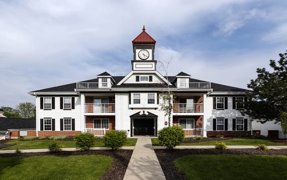 a large white building with a clock tower on top of it