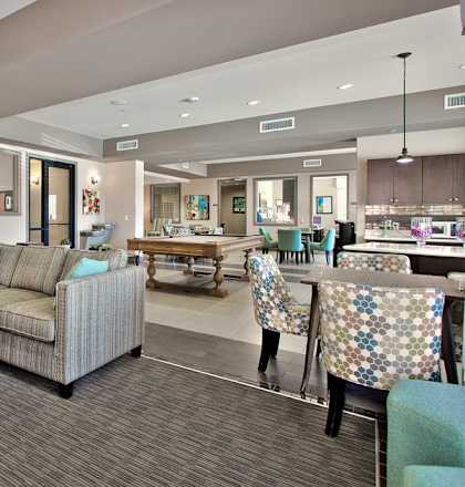 A living room with a couch, chairs, and a coffee table.