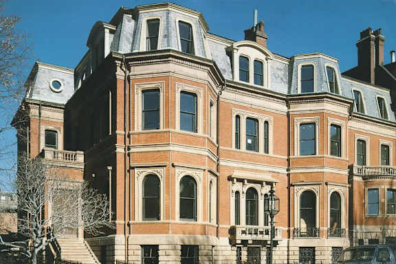 A large, ornate building with a red brick facade and white trim.
