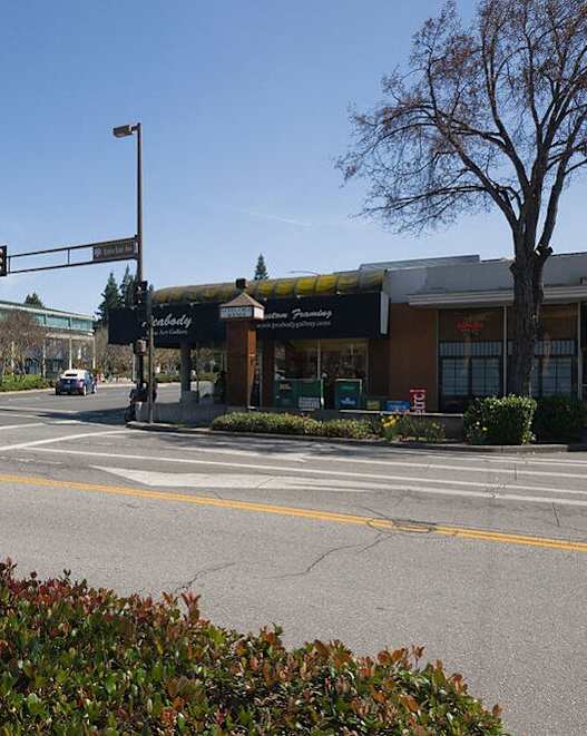 A street view with a traffic light and a car on the road.