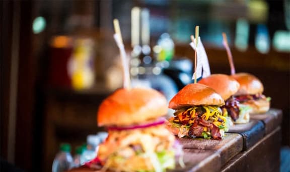 a selection of sandwiches on a wooden counter