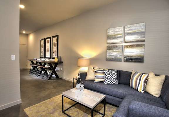 A living room with a grey couch and a coffee table.
