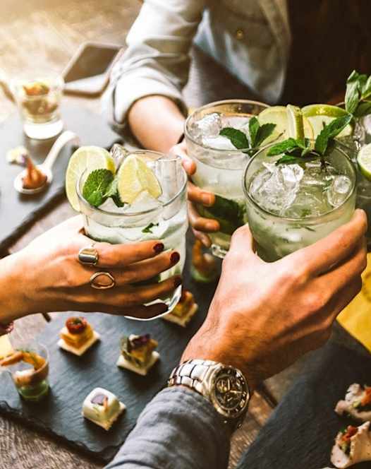 Group of people holding up cocktails at The Groves Apartments, North Carolina