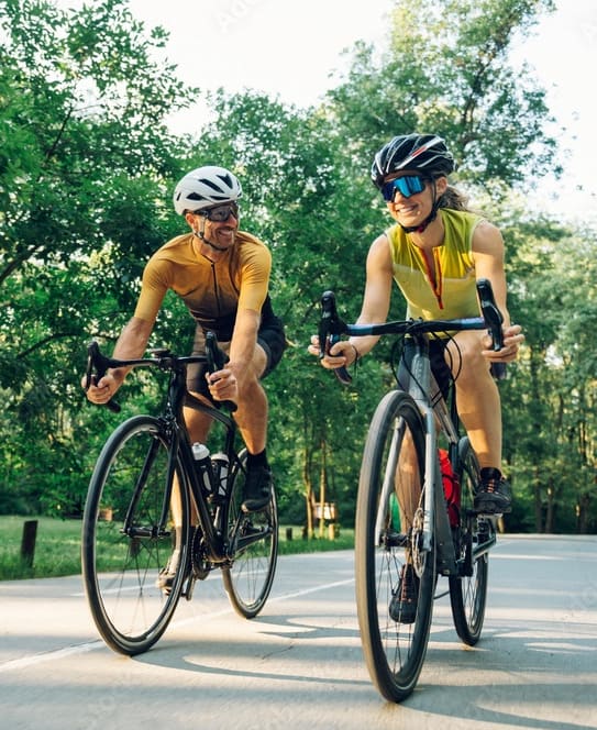 two people riding bikes down a street at Granville Oaks Apartment Homes, Creedmoor, NC 27522