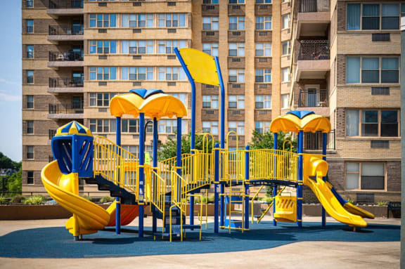 a playground at an apartment complex with yellow and blue equipment at Parkview Towers, Collingswood, NJ, 08107