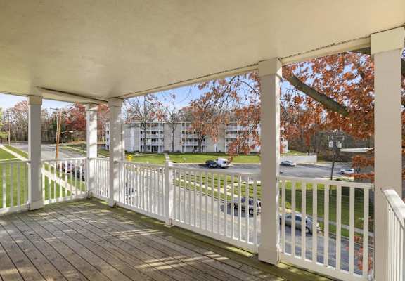 a porch with a view of a parking lot