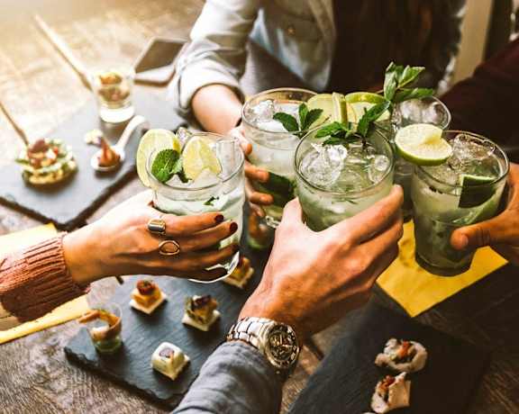 a group of people holding up cocktails at a table  at Lexington on the Green, North Carolina, 27604