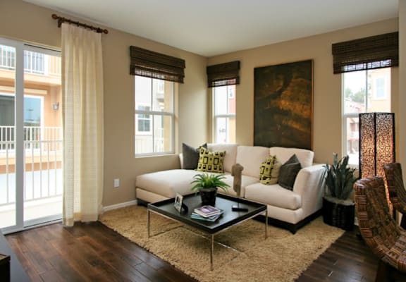 a living room with a white couch and a brown rug