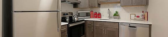 a kitchen with stainless steel appliances and wooden cabinets