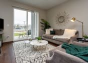 Thumbnail 7 of 26 - living room with doors to patio, couch, and coffeetable
