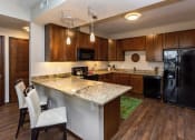 Thumbnail 10 of 26 - kitchen with fridge, oven, and countertops used for additional seating