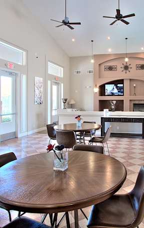 A pool table is in the middle of a room with a TV and a chair.
