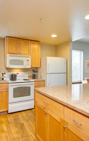 a kitchen with white appliances and wooden cabinets