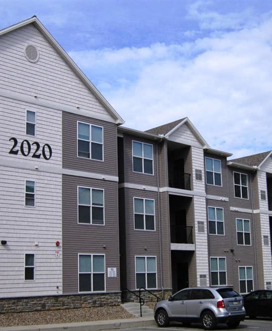 a row of three story houses on a street