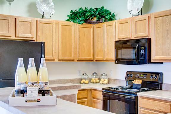 A kitchen with wooden cabinets and a black stove top oven.