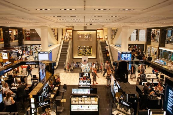 the inside of a busy shopping mall with many different retail counters