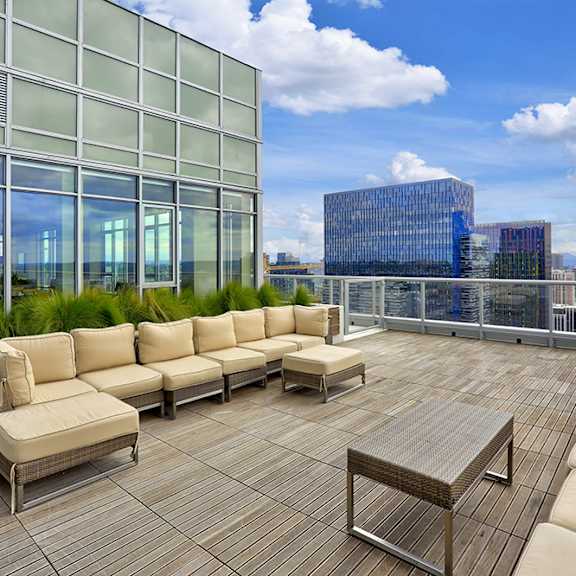 a terrace with couches and a table on a roof